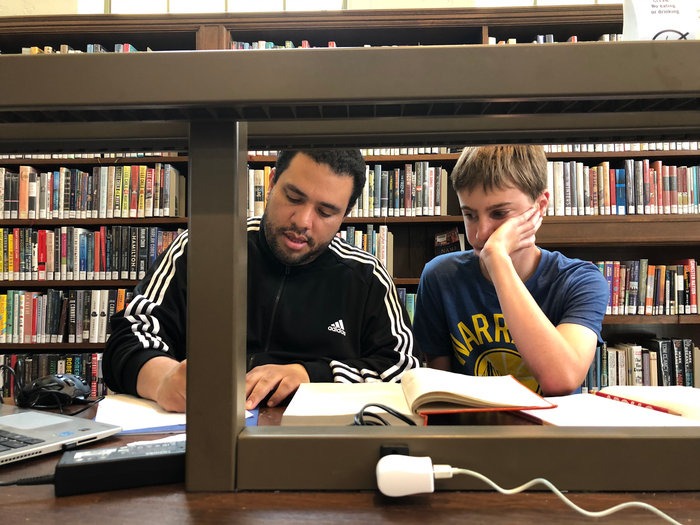 Felix tutoring one on one in a library