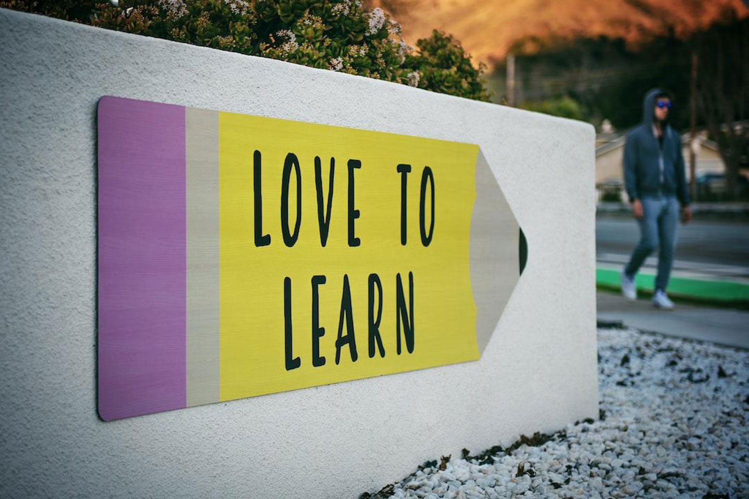 Sign on a wall that says Love To Learn