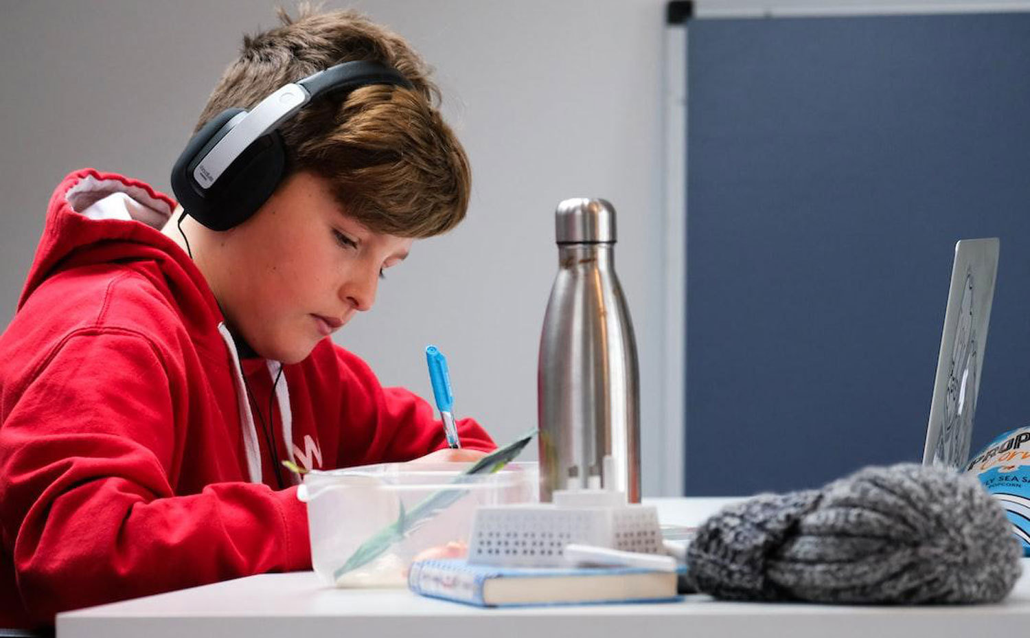 Boy, taking, a, test, with, headphones, on Boy taking a test with headphones on