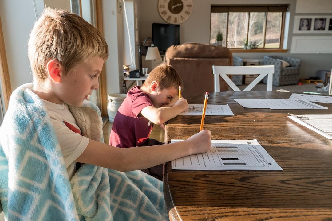 two boys doing math work at table