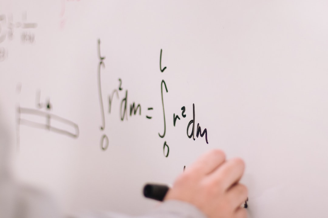 A closeup of a student working on math problems on a whiteboard.