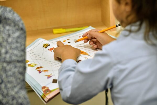 An over-the-shoulder view of a student learning 1 on 1 with a tutor.