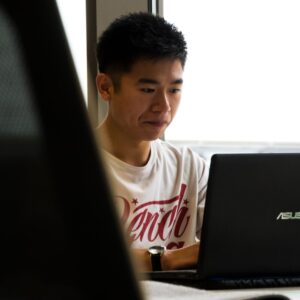 A student studying with a math tutor on his laptop.