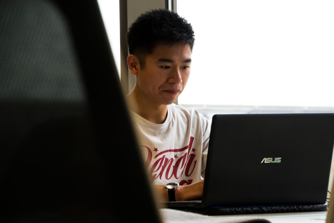A student studying with a math tutor on his laptop.