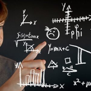 A young student points at math equations on a board.