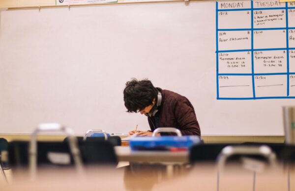 Student studying in classroom, representing 12th grade math learning and preparation