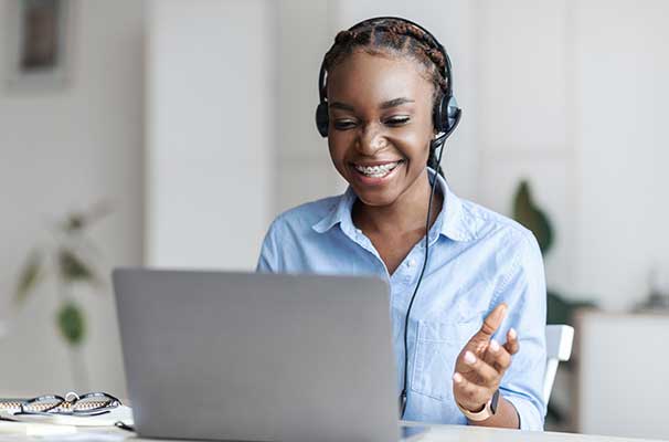 Online tutoring. Black female tutor in headset having video conference with laptop