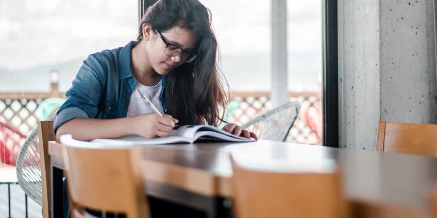 Girl studying with book and pencil