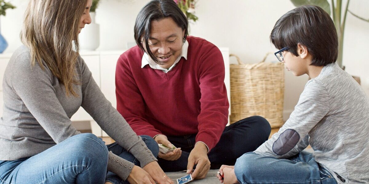 Family playing a number card game